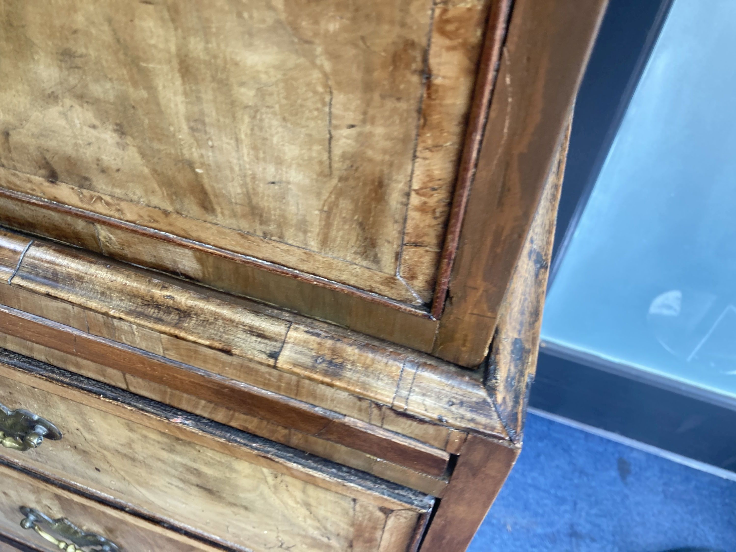 An early 18th century banded walnut tallboy, with oak sides, fitted three small and six long drawers with a brushing slide, width 105cm